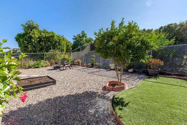 1523 Temple Heights Dr, Oceanside, CA 92056 - fenced backyard featuring an outdoor fire pit and a putting area