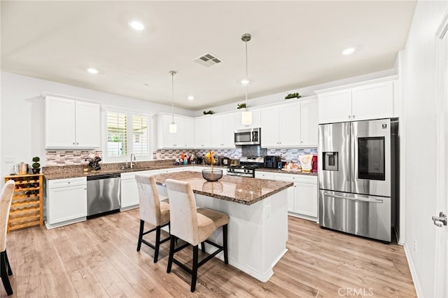 27555 Mountainside St, Menifee, CA 92584 - kitchen with appliances with stainless steel finishes, tasteful backsplash, white cabinetry, and recessed lighting