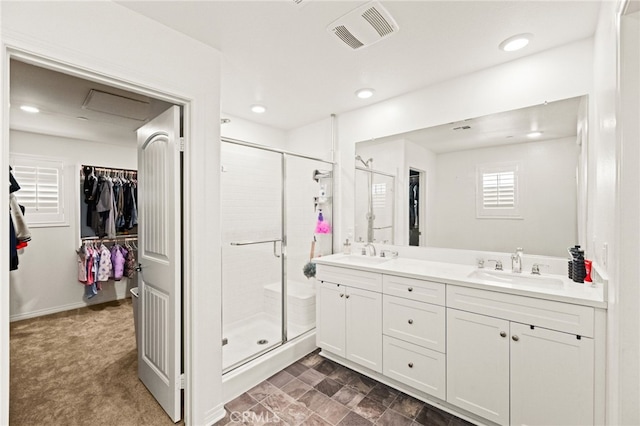 27555 Mountainside St, Menifee, CA 92584 - bathroom featuring a shower stall, double vanity, a walk in closet, and recessed lighting