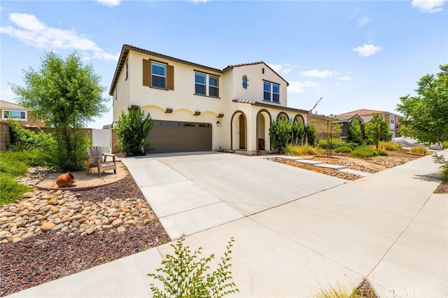 27555 Mountainside St, Menifee, CA 92584 - mediterranean / spanish home featuring driveway, an attached garage, stucco siding, and a tiled roof