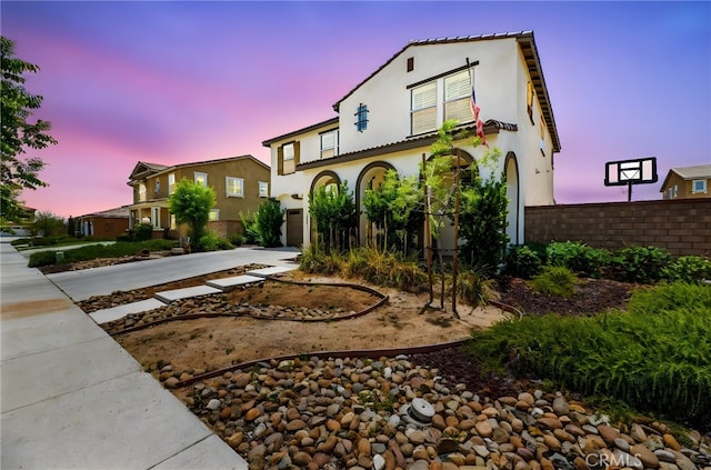 27555 Mountainside St, Menifee, CA 92584 - mediterranean / spanish home featuring driveway, stucco siding, and a garage