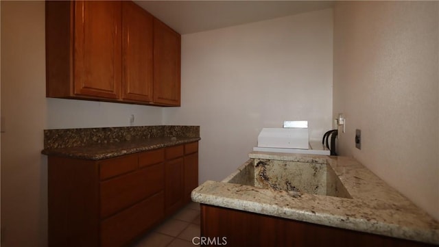16141 Jessie St, Lower Lake, CA 95457 - kitchen featuring brown cabinetry, light stone countertops, and light tile patterned floors