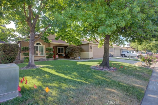 1320 Fairway Dr, Atwater, CA 95301 - view of property hidden behind natural elements featuring stucco siding, a front lawn, concrete driveway, a garage, and a tile roof