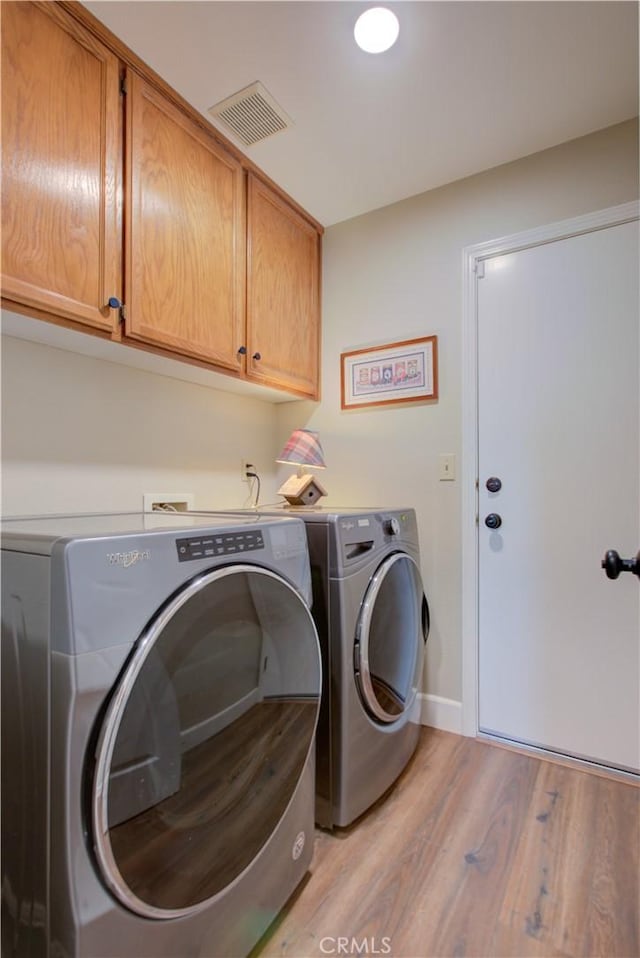 1320 Fairway Dr, Atwater, CA 95301 - laundry area featuring cabinet space, separate washer and dryer, and light wood finished floors