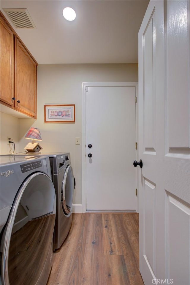 1320 Fairway Dr, Atwater, CA 95301 - laundry room featuring cabinet space, separate washer and dryer, and wood finished floors