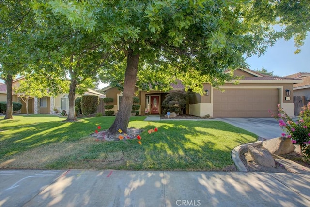 1320 Fairway Dr, Atwater, CA 95301 - view of property hidden behind natural elements featuring an attached garage, stucco siding, concrete driveway, and a front lawn