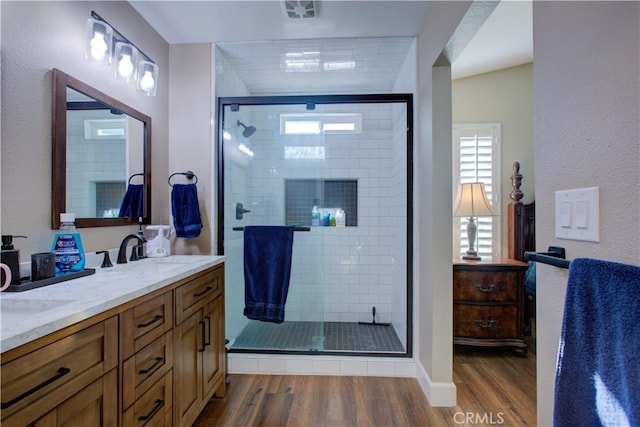 1320 Fairway Dr, Atwater, CA 95301 - bathroom with wood finished floors, double vanity, and a stall shower