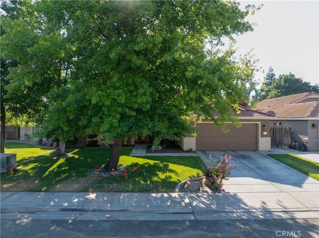 1320 Fairway Dr, Atwater, CA 95301 - obstructed view of property featuring stucco siding, a garage, driveway, and a tiled roof