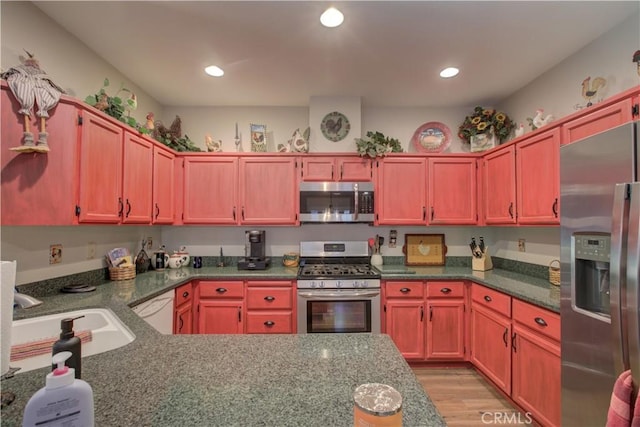 1320 Fairway Dr, Atwater, CA 95301 - kitchen with stainless steel appliances, light wood finished floors, recessed lighting, and dark stone counters