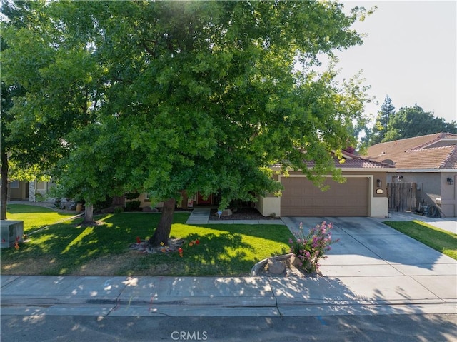 1320 Fairway Dr, Atwater, CA 95301 - obstructed view of property featuring stucco siding, a garage, driveway, and a tiled roof
