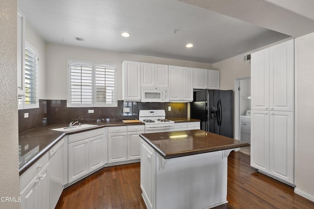 104 W Santa Clara St, Ventura, CA 93001 - kitchen with white appliances, dark countertops, dark wood finished floors, white cabinetry, and backsplash