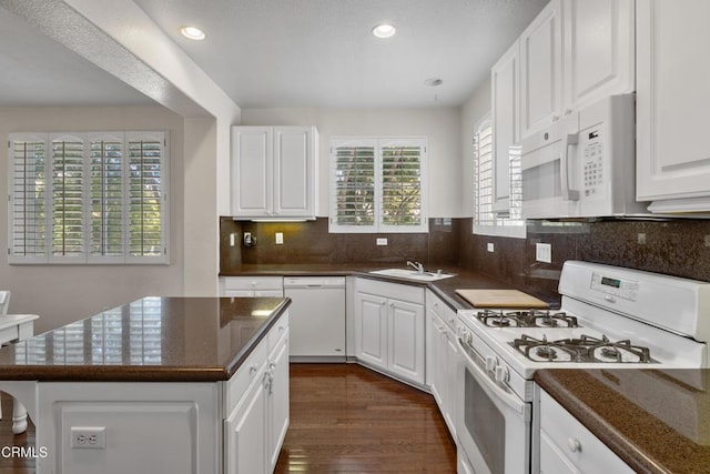 104 W Santa Clara St, Ventura, CA 93001 - kitchen with white appliances, dark countertops, white cabinetry, dark wood finished floors, and recessed lighting