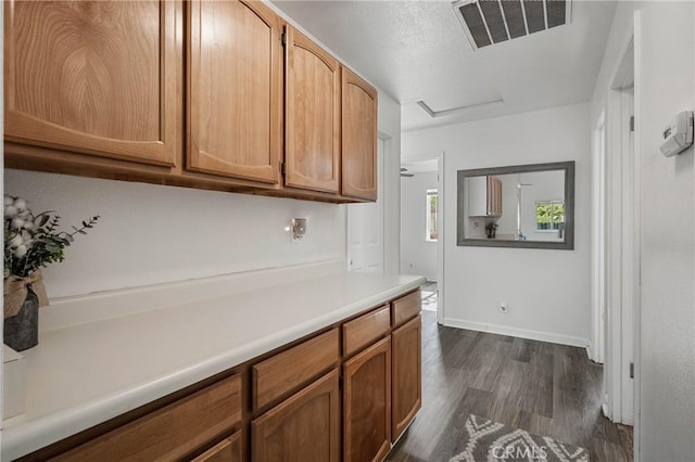 4742 Pauline Pl, Kelseyville, CA 95451 - kitchen with dark wood-type flooring, light countertops, and brown cabinets