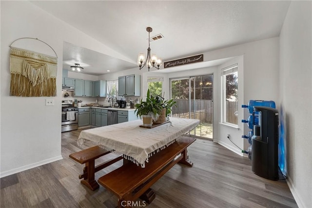 4742 Pauline Pl, Kelseyville, CA 95451 - dining room featuring dark wood-style flooring, vaulted ceiling, and a chandelier