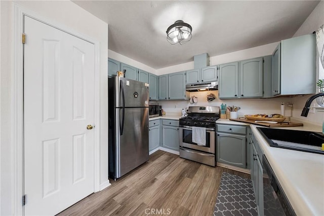 4742 Pauline Pl, Kelseyville, CA 95451 - kitchen with stainless steel appliances, under cabinet range hood, wood finished floors, and light countertops