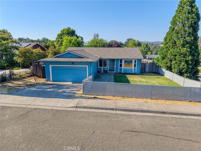 4742 Pauline Pl, Kelseyville, CA 95451 - view of front of house featuring concrete driveway, a fenced front yard, and an attached garage