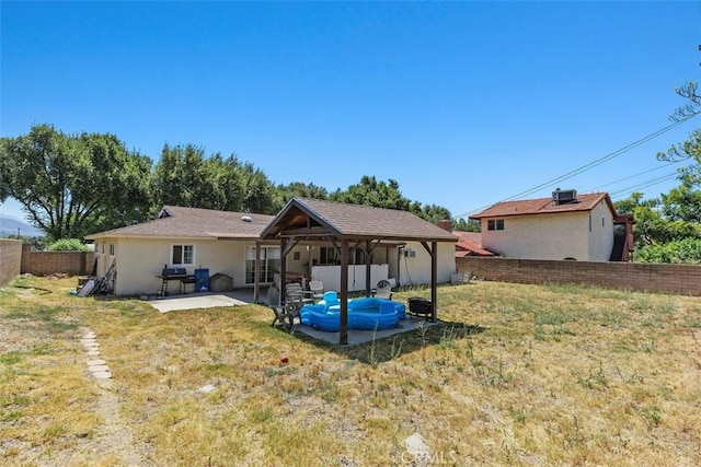 5228 N G St, San Bernardino, CA 92407 - rear view of house with a patio, a fenced backyard, and stucco siding