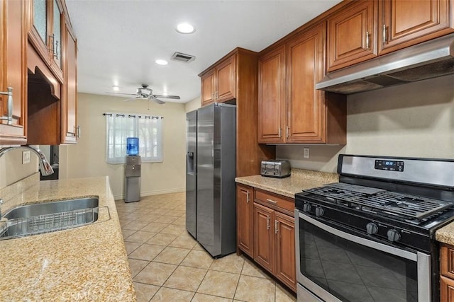 5228 N G St, San Bernardino, CA 92407 - kitchen featuring stainless steel appliances, range hood, light tile patterned floors, ceiling fan, and brown cabinetry