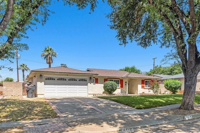5228 N G St, San Bernardino, CA 92407 - ranch-style home with stucco siding, a garage, driveway, and a front lawn