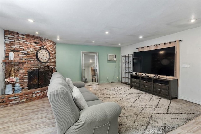 5228 N G St, San Bernardino, CA 92407 - living room featuring wood finished floors, a wall unit AC, recessed lighting, and a fireplace