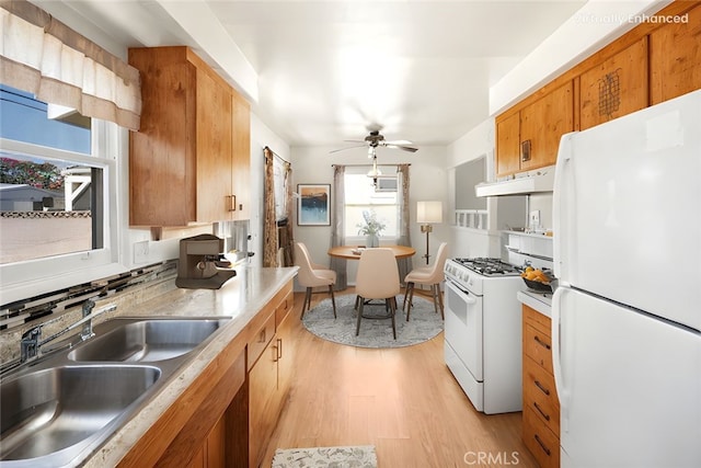 473 W Roberta Ave, Fullerton, CA 92832 - kitchen featuring white appliances, light wood-style floors, under cabinet range hood, a ceiling fan, and light countertops