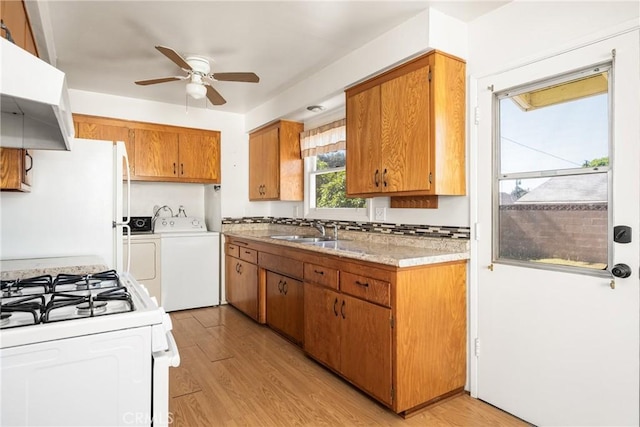 473 W Roberta Ave, Fullerton, CA 92832 - kitchen with under cabinet range hood, white appliances, separate washer and dryer, ceiling fan, and light wood finished floors