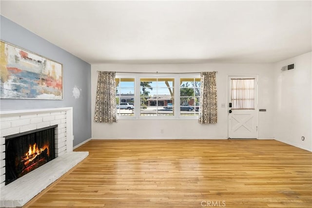 473 W Roberta Ave, Fullerton, CA 92832 - unfurnished living room with a brick fireplace and light wood finished floors