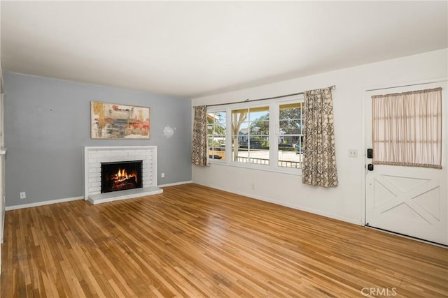 473 W Roberta Ave, Fullerton, CA 92832 - unfurnished living room with a brick fireplace and light wood-style flooring