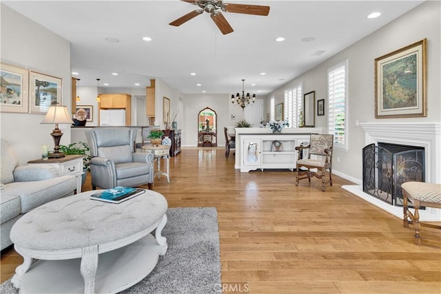 2757 Traditions, Paso Robles, CA 93446 - living room with ceiling fan, light wood finished floors, recessed lighting, a chandelier, and a fireplace with raised hearth