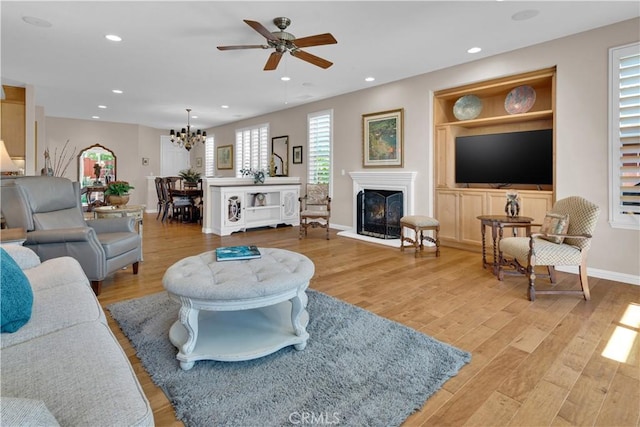 2757 Traditions, Paso Robles, CA 93446 - living room featuring a ceiling fan, light wood-style floors, a fireplace with raised hearth, and recessed lighting