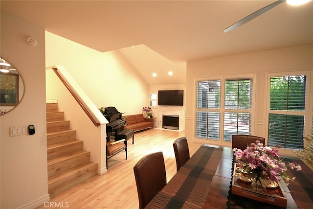 800 Via Colinas, Westlake Village, CA 91362 - dining space featuring wood finished floors, a fireplace, stairs, and vaulted ceiling