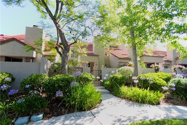 800 Via Colinas, Westlake Village, CA 91362 - view of front of property with stucco siding, a tiled roof, a gate, and a chimney