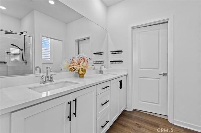 4408 S Grant Paseo, Ontario, CA 91762 - full bathroom with double vanity, a shower stall, recessed lighting, and wood finished floors