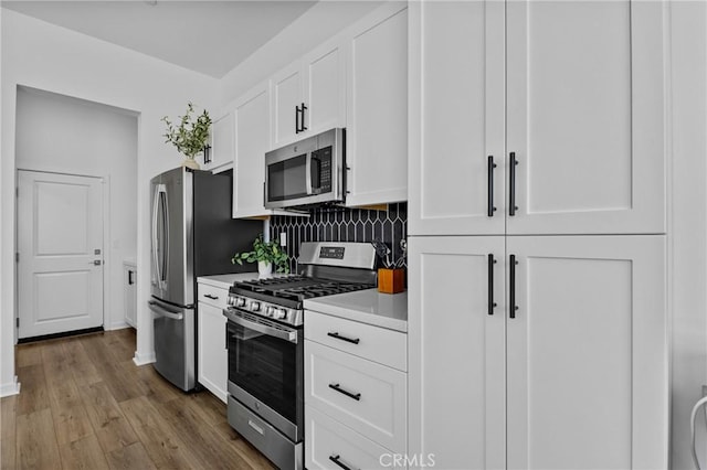 4408 S Grant Paseo, Ontario, CA 91762 - kitchen featuring stainless steel appliances, light countertops, white cabinets, wood finished floors, and decorative backsplash