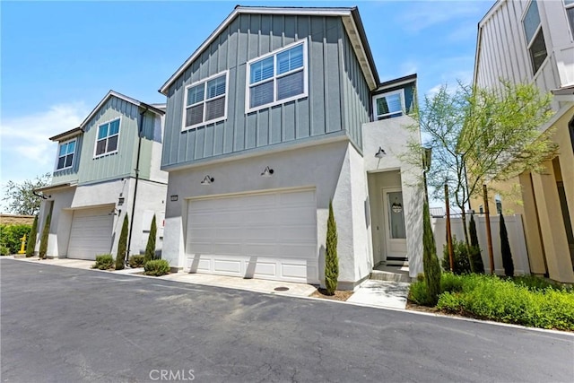 4408 S Grant Paseo, Ontario, CA 91762 - view of front of home with board and batten siding, a garage, and stucco siding