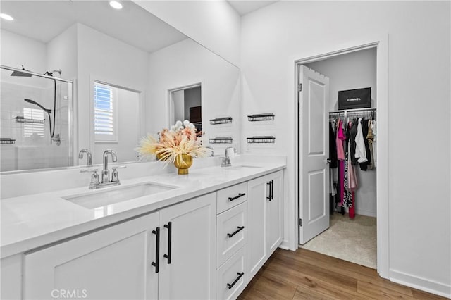 4408 S Grant Paseo, Ontario, CA 91762 - full bathroom featuring a stall shower, double vanity, recessed lighting, wood finished floors, and a walk in closet