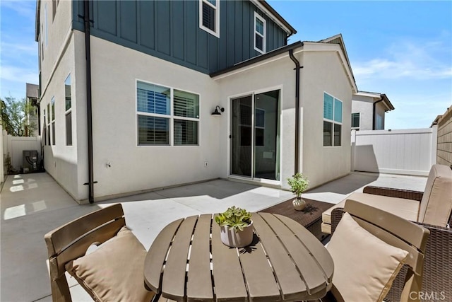 4408 S Grant Paseo, Ontario, CA 91762 - rear view of property featuring board and batten siding, a patio area, a fenced backyard, and stucco siding
