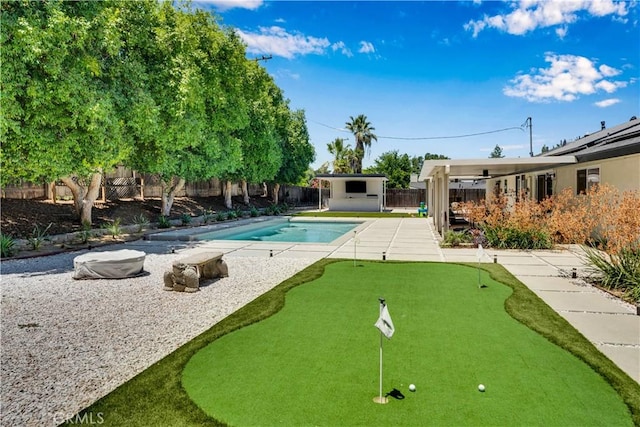 406 Eucalyptus Dr, Redlands, CA 92373 - surrounding community featuring a fenced backyard, an area to practice putting, a pool, and a patio area