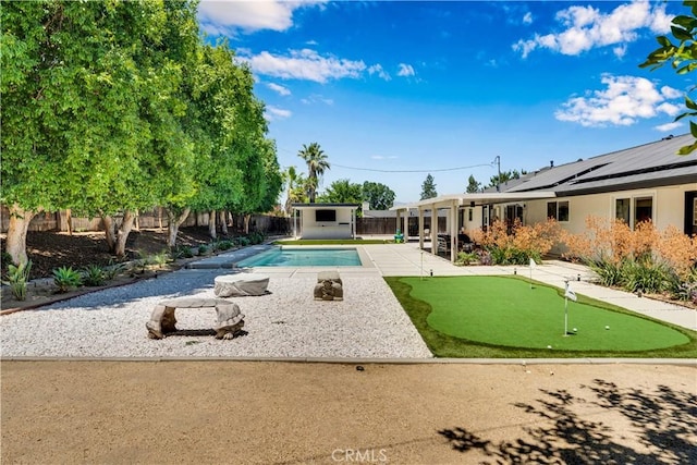 406 Eucalyptus Dr, Redlands, CA 92373 - view of pool featuring a putting area, a patio area, a fenced backyard, and a shed