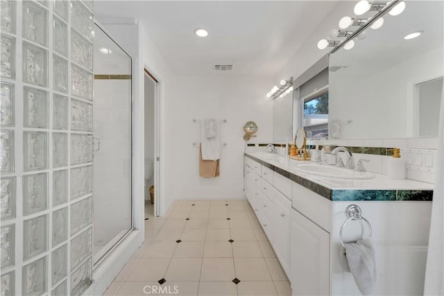 406 Eucalyptus Dr, Redlands, CA 92373 - bathroom featuring tiled shower, double vanity, tile patterned flooring, and recessed lighting