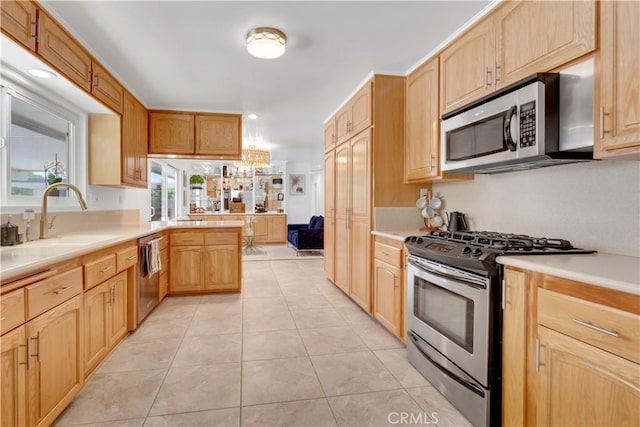 406 Eucalyptus Dr, Redlands, CA 92373 - kitchen featuring stainless steel appliances, light countertops, light tile patterned flooring, a peninsula, and light brown cabinetry