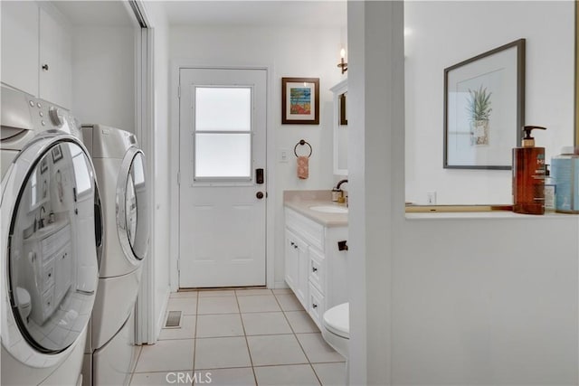 406 Eucalyptus Dr, Redlands, CA 92373 - washroom with washer and dryer and light tile patterned floors