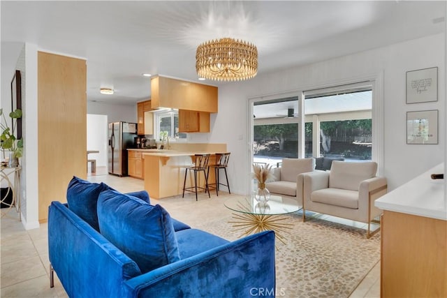 406 Eucalyptus Dr, Redlands, CA 92373 - living area featuring healthy amount of natural light, a chandelier, and light tile patterned floors