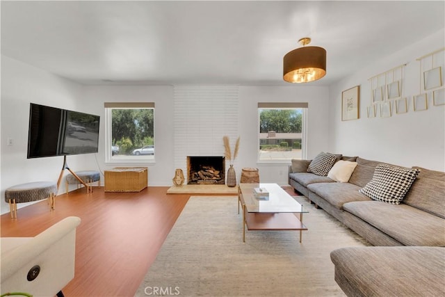 406 Eucalyptus Dr, Redlands, CA 92373 - living area with healthy amount of natural light, wood finished floors, and a fireplace