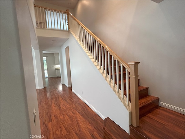 39877 Worthington Pl, Temecula, CA 92591 - staircase featuring wood finished floors and a towering ceiling