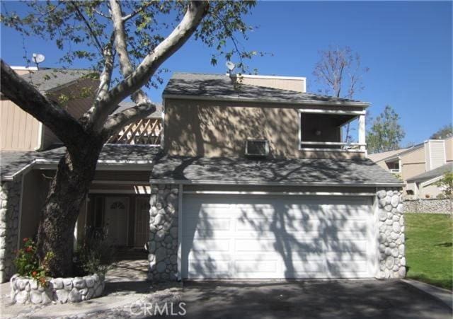 23551 Avenida La Caza Unit 129, Coto De Caza, CA 92679 - view of front of property with an attached garage, driveway, and a shingled roof