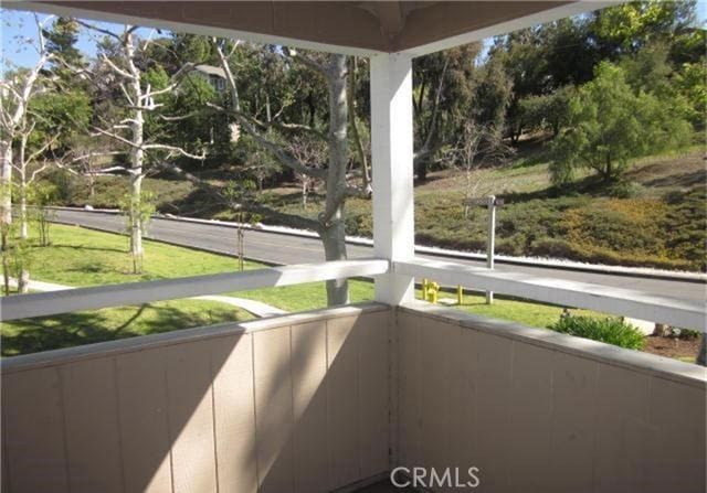 23551 Avenida La Caza Unit 129, Coto De Caza, CA 92679 - unfurnished sunroom featuring view of wooded area