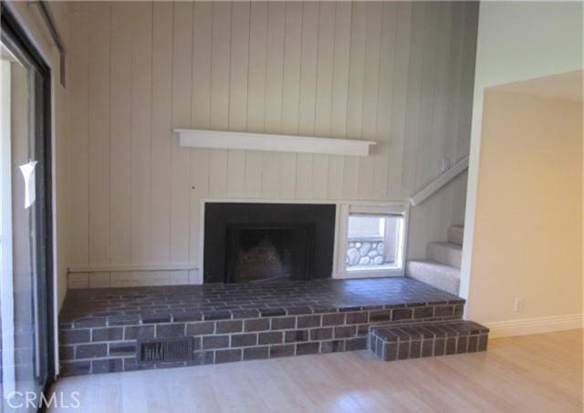 23551 Avenida La Caza Unit 129, Coto De Caza, CA 92679 - detailed view of wood finished floors, a fireplace, and wood walls