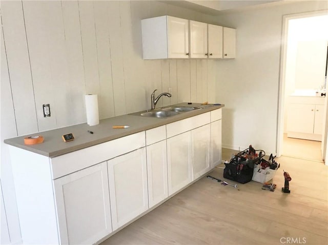 23551 Avenida La Caza Unit 129, Coto De Caza, CA 92679 - kitchen featuring light wood finished floors and white cabinets