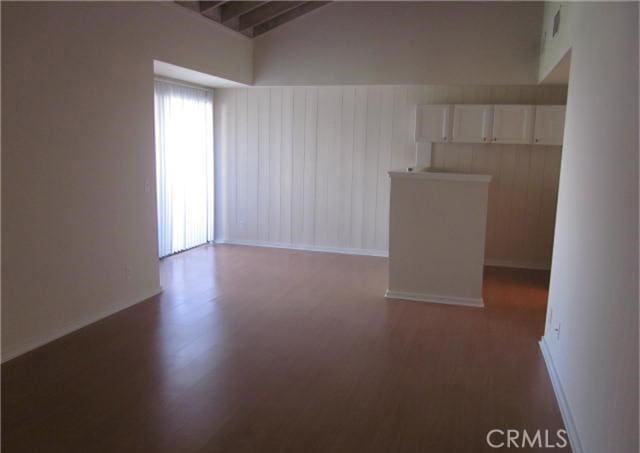 23551 Avenida La Caza Unit 129, Coto De Caza, CA 92679 - spare room featuring lofted ceiling, wood finished floors, and wood walls